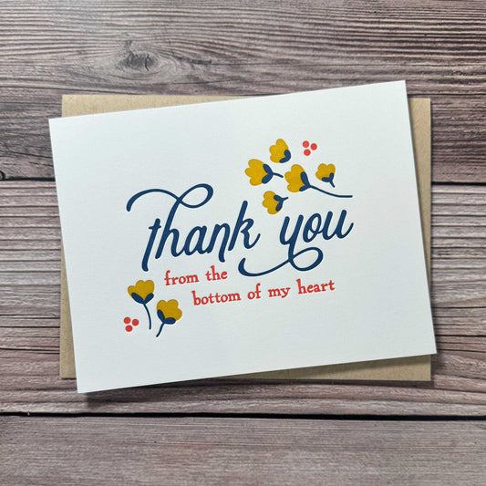 Greeting Card, Letterpress printed, Floral Design, Yellow, blue and Red. "Thank you from the bottom of my heart." These elegant cards are perfect for expressing your appreciation in a thoughtful and personal way, whether for business or personal use. Our Letterpress Thank You Cards are designed with quality in mind, providing a timeless, textured feel that adds a special touch to your messages. Perfect for Graduation thank you cards, Wedding thank you cards, Funeral thank you cards, business thank you cards
