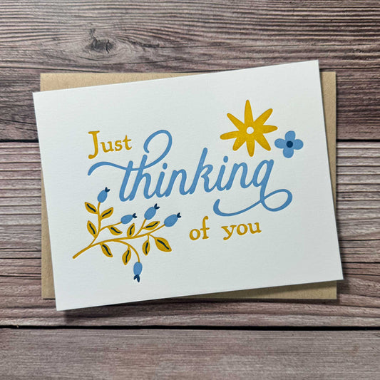 "Thinking of You" card. Floral Design, blue and yellow, letterpress printed with Kraft Envelope. Whether you’re reaching out to offer emotional support, checking on a friend, or sending encouragement during a difficult time, this card is the perfect way to express your care. With a beautiful letterpress design, it’s ideal for those navigating a difficult situation, surgery recovery, or needing a thoughtful Get Well Soon or Sympathy Card. Available in single card or boxed sets.