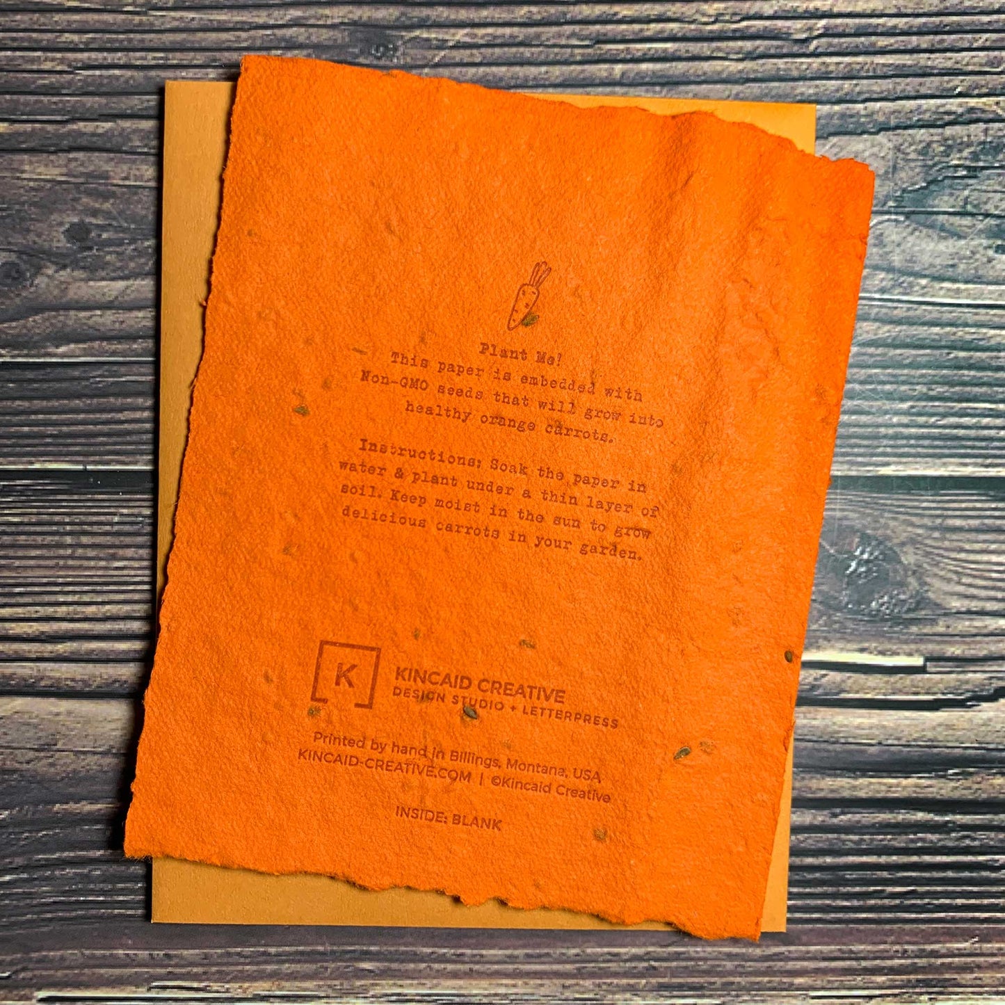 Letterpress plantable seed card, orange paper and envelopes, carrot seed paper, blank inside, back view of card, Kincaid Creative Design and Letterpress Studio, Bend, Oregon